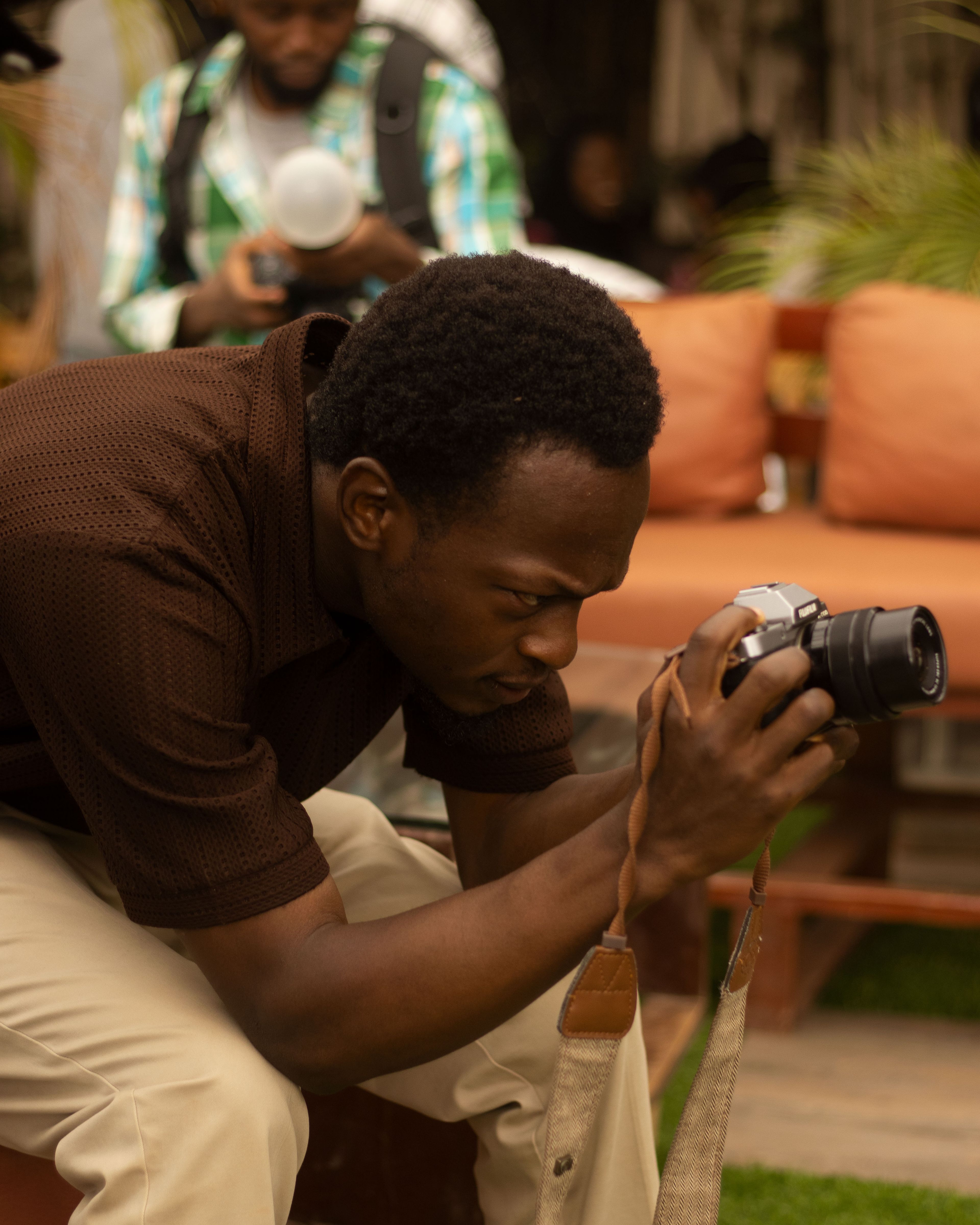 Photographer adjusting his camera settings in Jos, Nigeria
