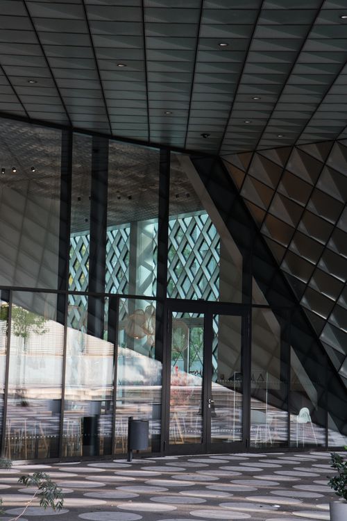 Free Intriguing geometric facade with reflections in a Berlin building exterior. Stock Photo
