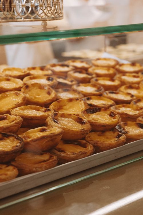 Free Freshly baked pasteis de nata on display in a traditional Porto bakery. Stock Photo