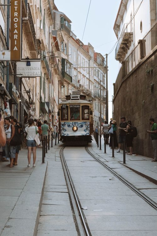Free Porto, Portugal's charming tram navigates through its historic district on a sunny day. Stock Photo