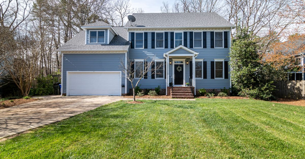 Bright suburban family home with spacious lawn and classic architecture.