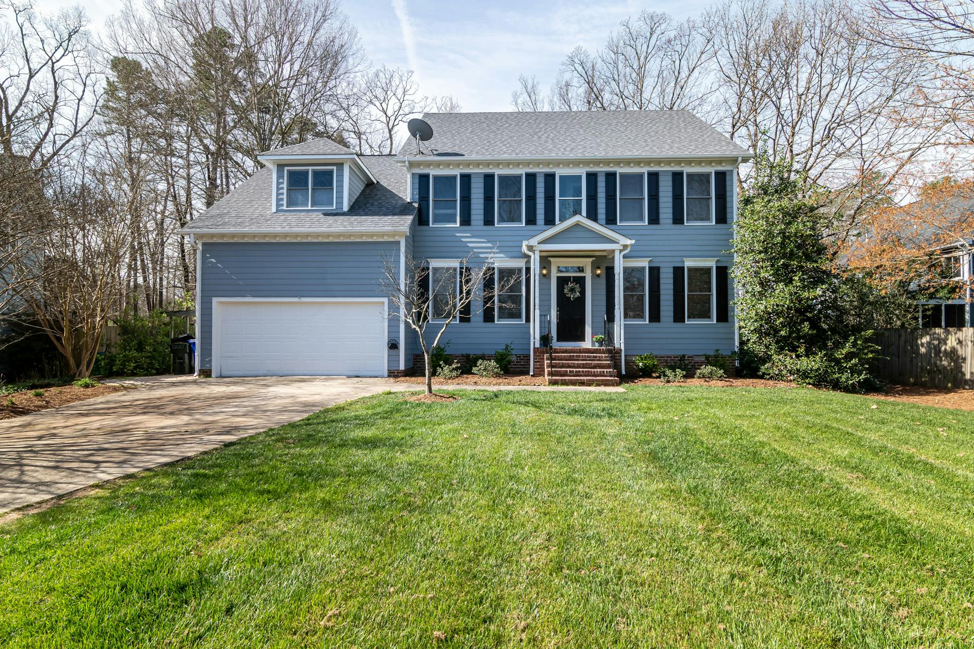 Bright suburban family home with spacious lawn and classic architecture.