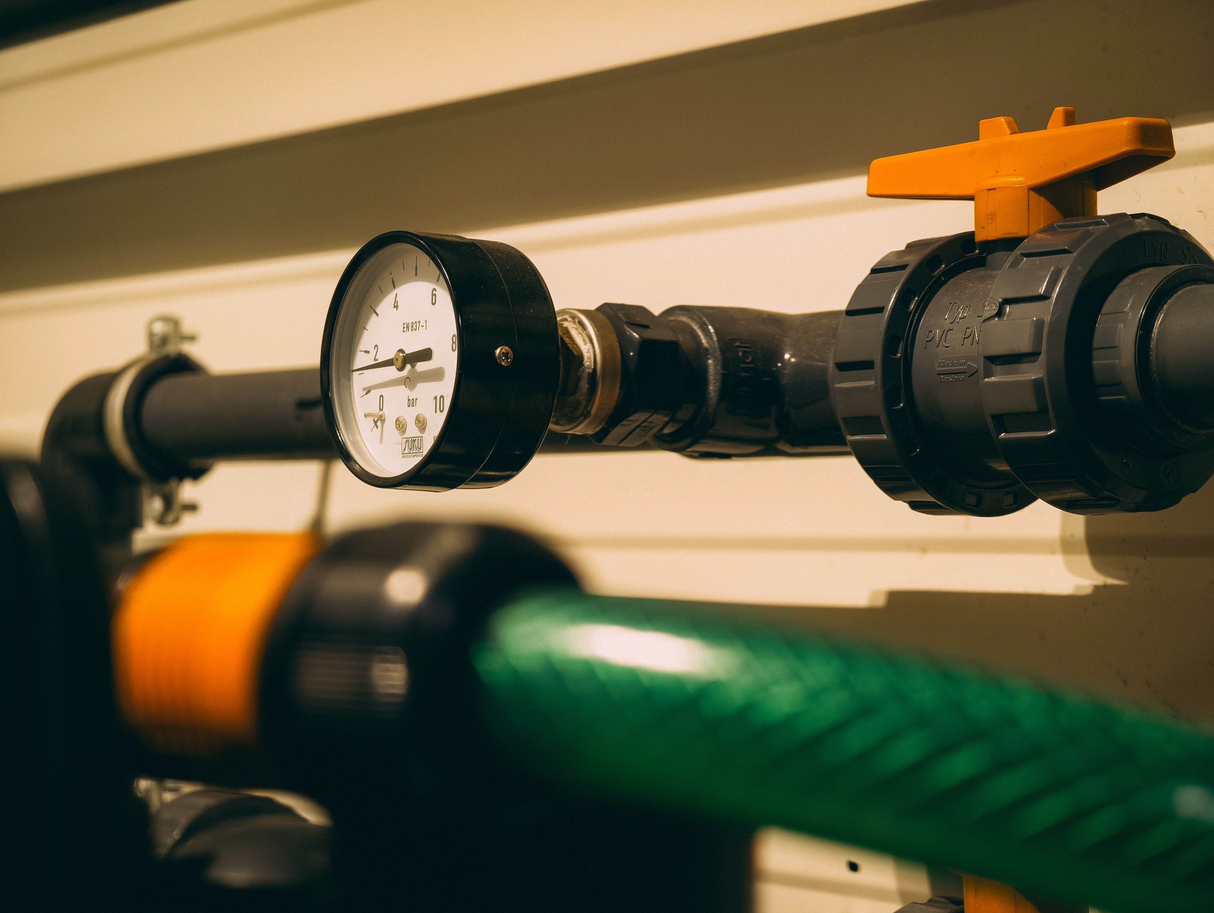 Plumbing tools and pipe fittings laid out on a workbench