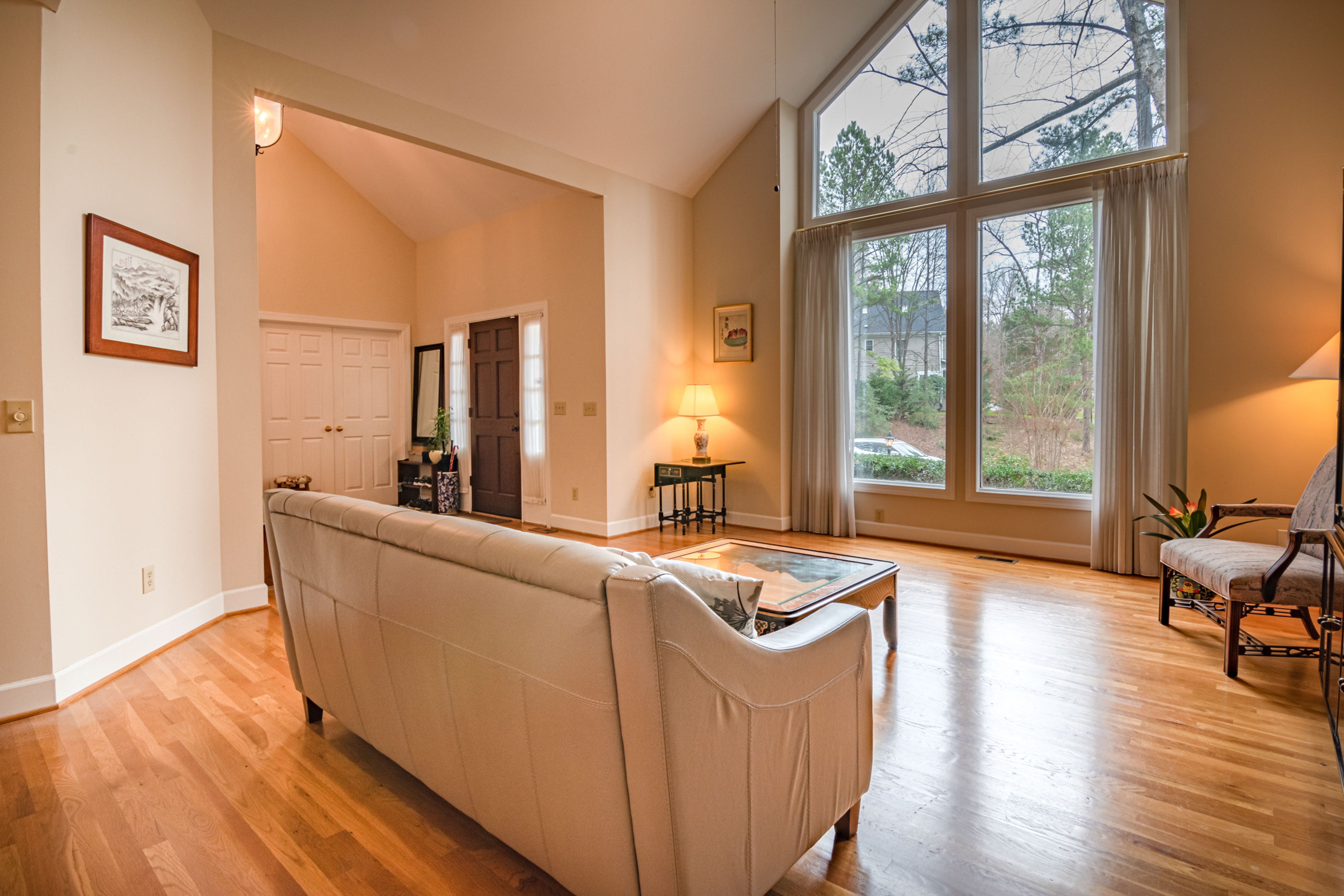 Alt Text: A cozy, modern living room beautifully staged with a comfortable sofa and a clean wooden coffee table in front of it.