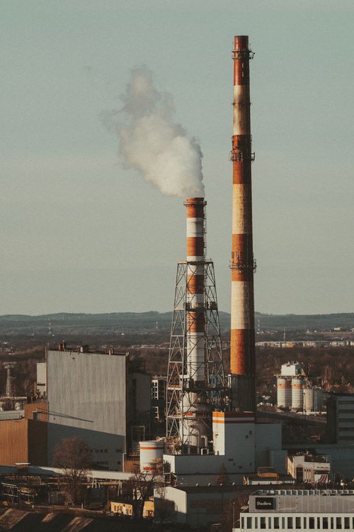 Free Outdoor view of industrial smokestacks releasing smoke, symbolizing environmental impact. Stock Photo