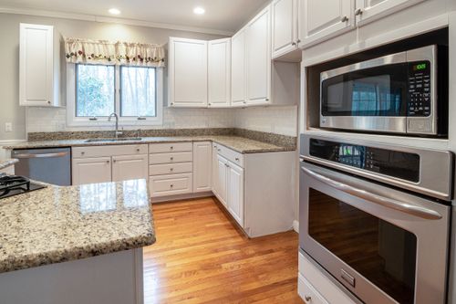 Free Spacious modern kitchen with white cabinets and granite countertops. Stock Photo