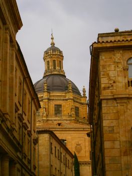 A tall dome rises among classic buildings, showcasing historic architecture.