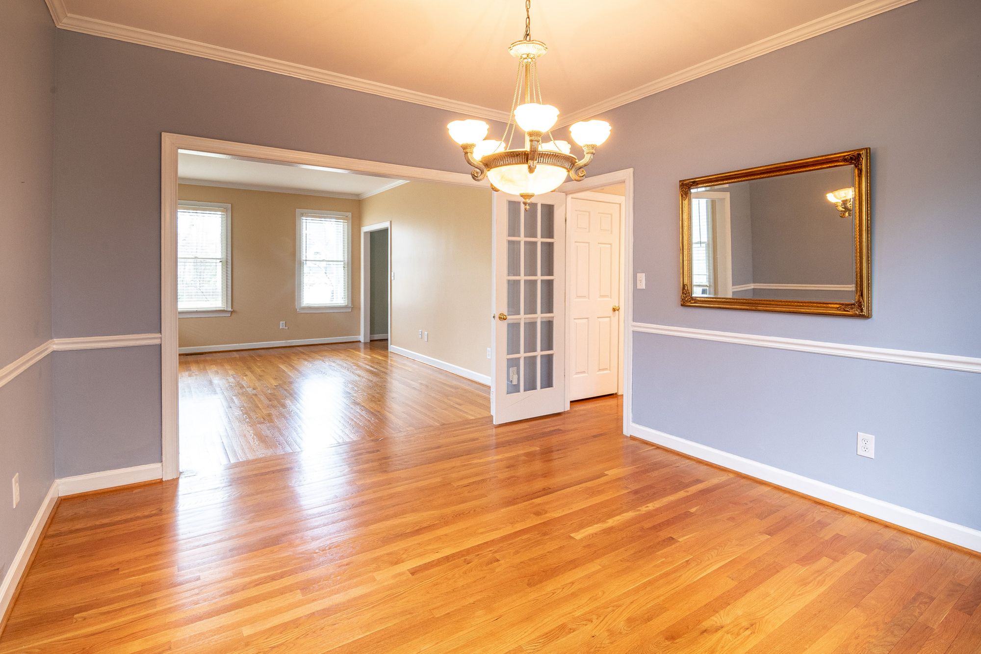Finished hardwood floor in a bright dining room