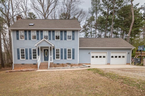 Brown and Gray Wooden House Near Bare Trees