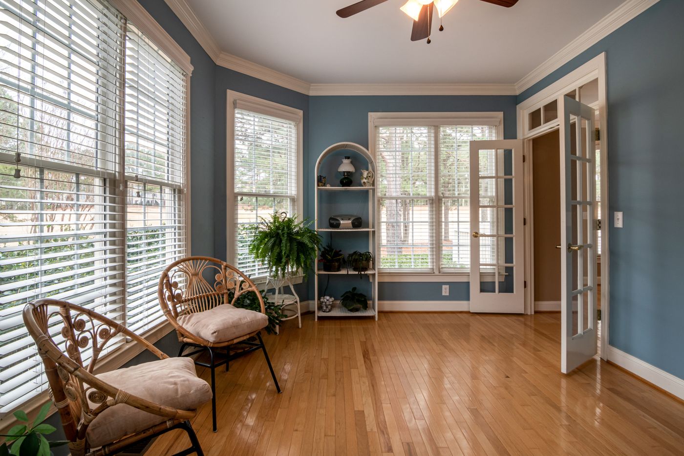 sunlit sunroom with hardwood floors and plantation shutters — real estate photographer Cape Town | ProShoot.io