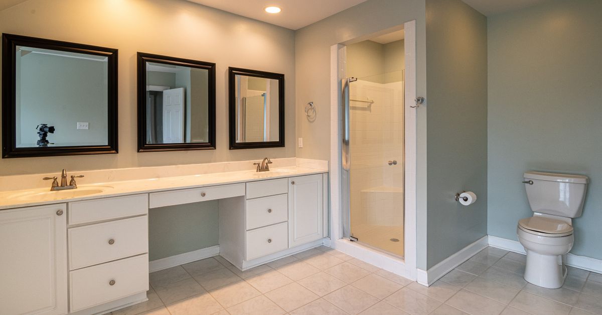 Spacious contemporary bathroom with dual sinks and a shower panel.