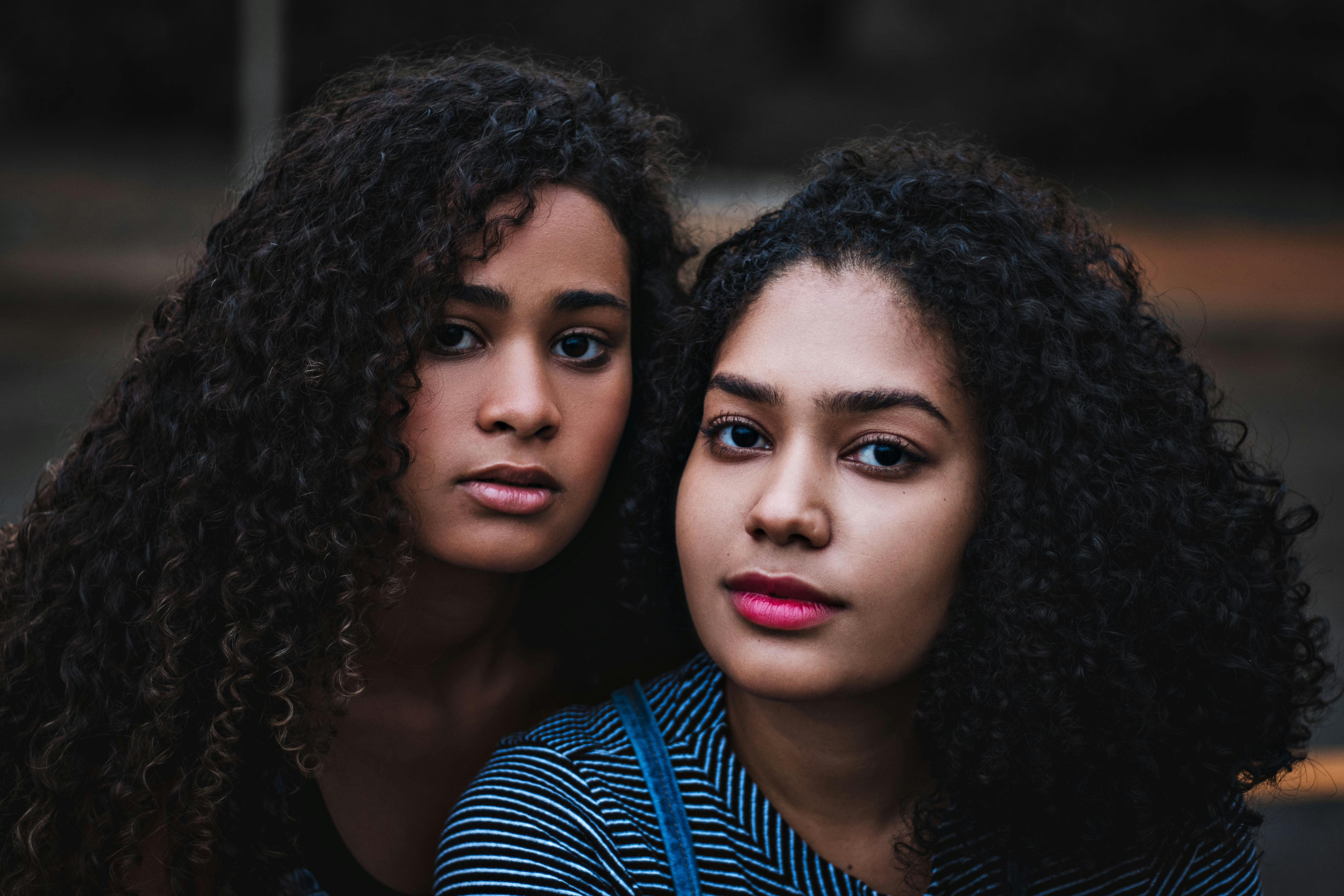 photo of woman beside each other