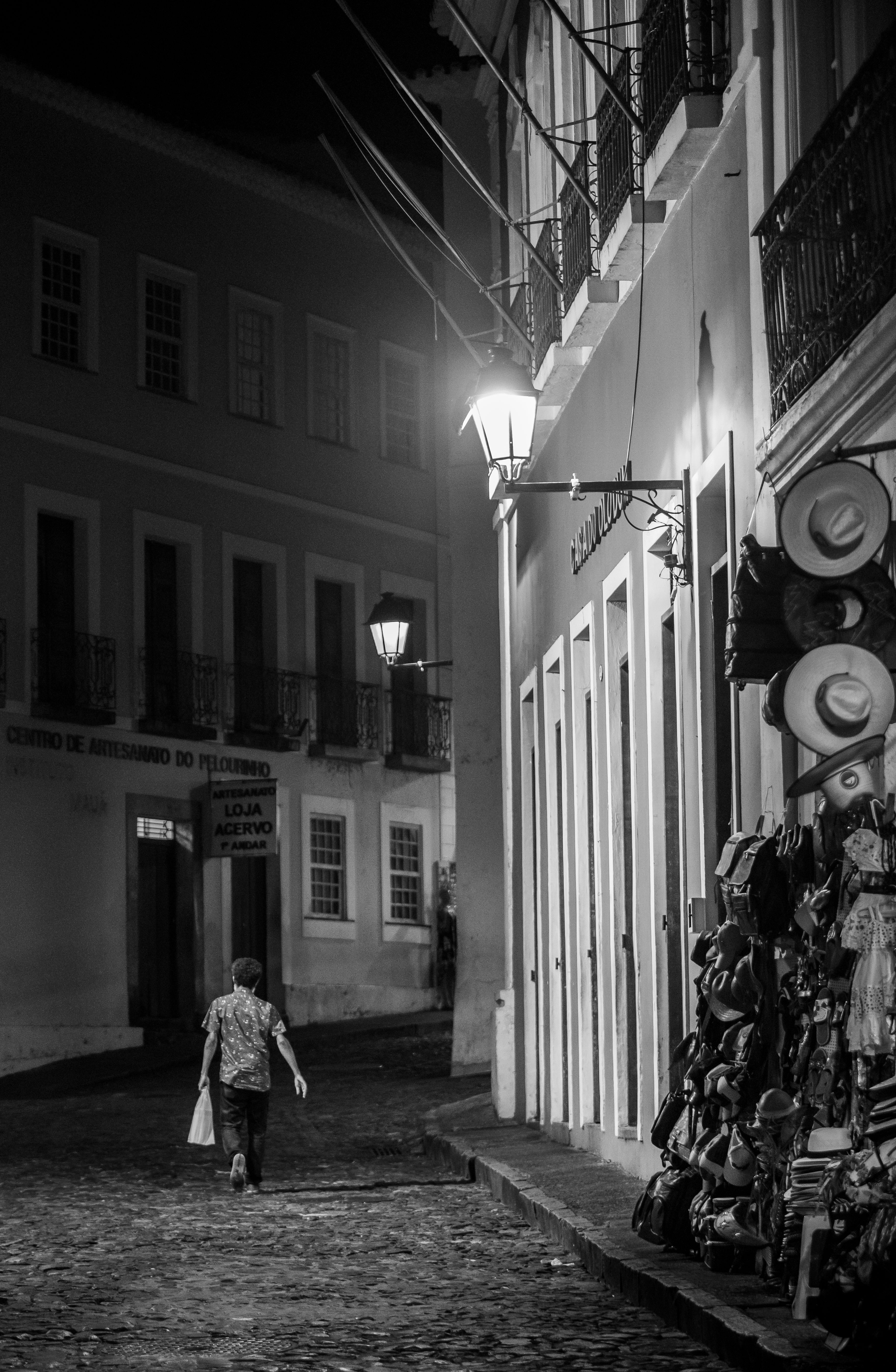 Grayscale Photo of a Man Walking on the Street · Free Stock Photo