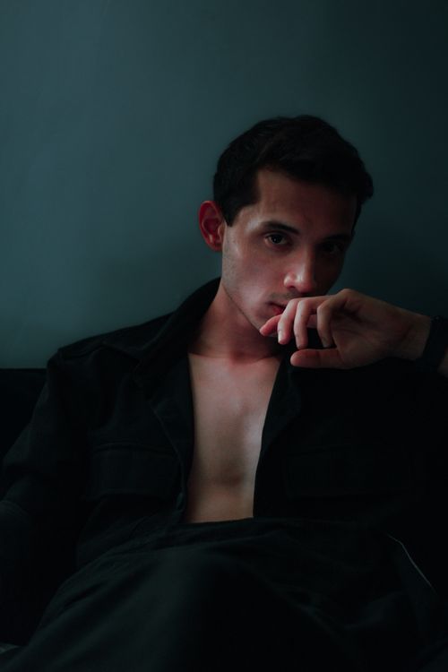 Free Moody portrait of a young man in deep thought, low light setting. Stock Photo