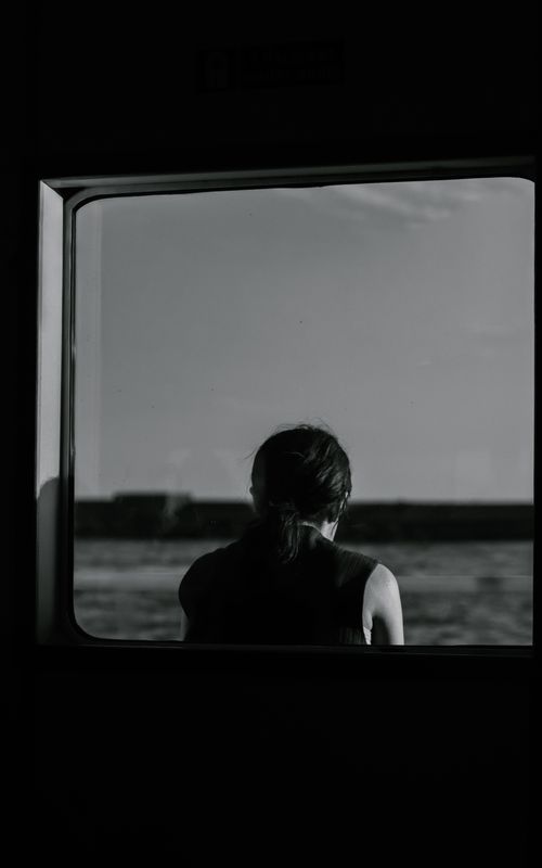 Free A contemplative silhouette gazes through a window, capturing serene views of the Bosphorus. Stock Photo