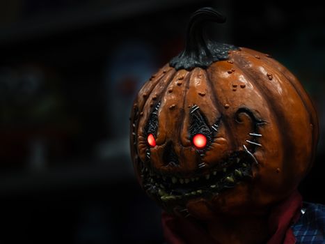 Dark and eerie pumpkin head with glowing eyes perfect for Halloween horror theme.
