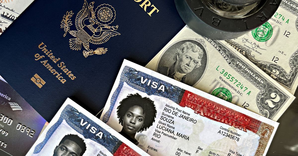 UK Skilled Worker Visa Residency Requirement: What You Need to Know — Close-up of a US passport, visa documents, currency, and stamps.