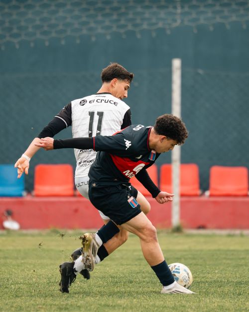 Free Two soccer players compete fiercely on a grassy outdoor field during the day. Stock Photo