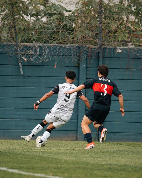 Free Two soccer players in action during a competitive match on a grassy field. Stock Photo