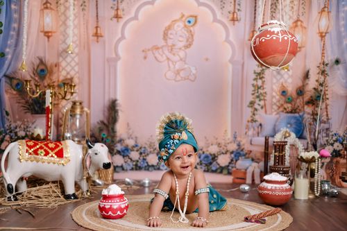 Free Charming baby in traditional Indian attire amidst Hindu Krishna festival decor. Stock Photo