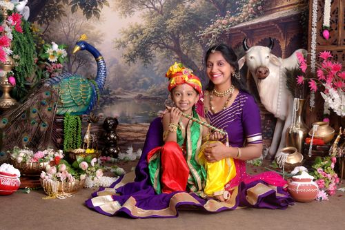 Free A vibrant family portrait featuring traditional Indian attire and decor. Stock Photo