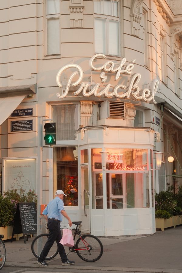 A peaceful evening scene outside the iconic Café Prückel in Vienna's cityscape.