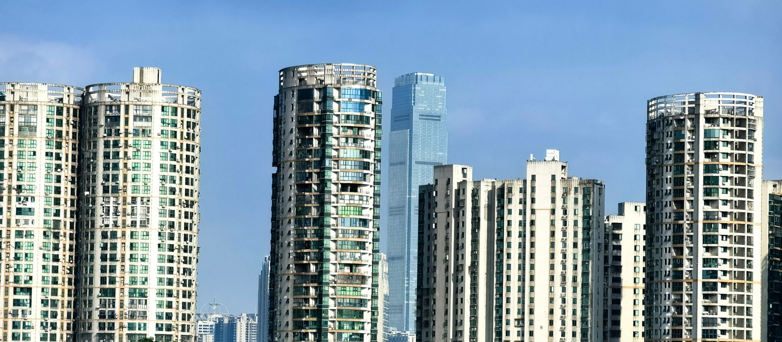 Panoramic view of Changsha's urban skyline showcasing modern high-rise buildings against a blue sky. — flights from Kuala Lumpur to Changsha