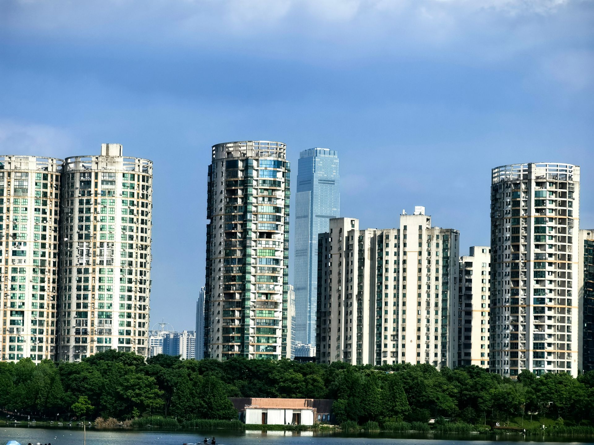 Panoramic view of Changsha's urban skyline showcasing modern high-rise buildings against a blue sky.
