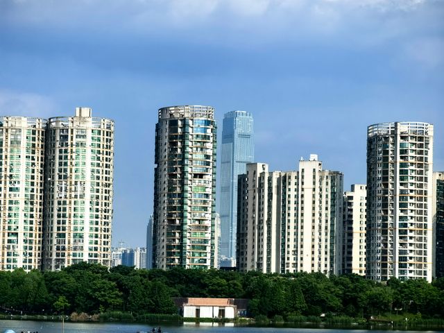Panoramic view of Changsha's urban skyline showcasing modern high-rise buildings against a blue sky.
