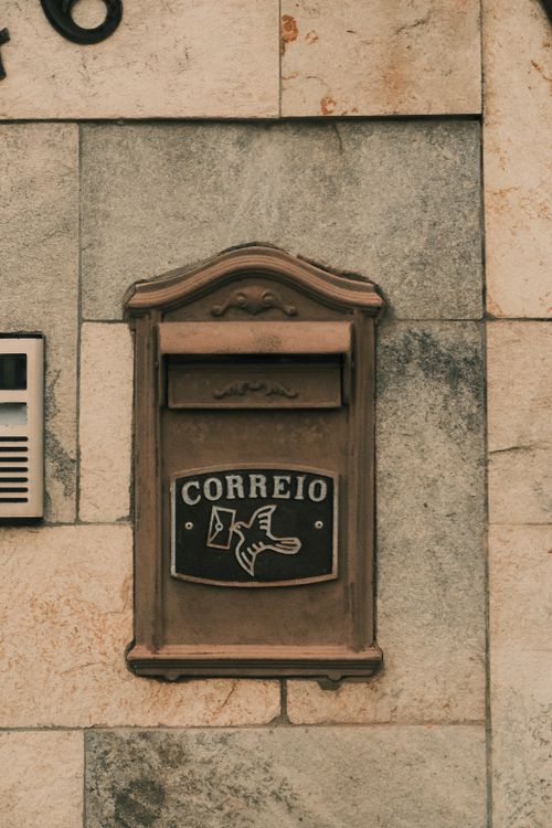 Free A rustic vintage mailbox labeled 'CORREIO' mounted on a stone wall in Brasil. Stock Photo
