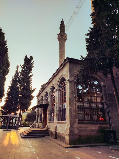 Free A beautiful mosque with a tall minaret in Samsun, Türkiye captured during sunset, highlighting architectural elegance. Stock Photo