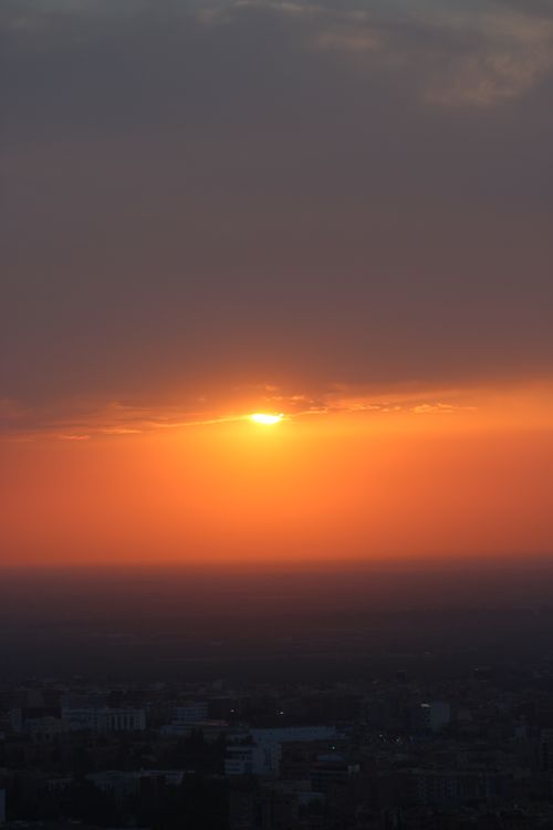 Free A breathtaking view of the sunset over Béni Mellal, Morocco, with a vibrant orange sky. Stock Photo
