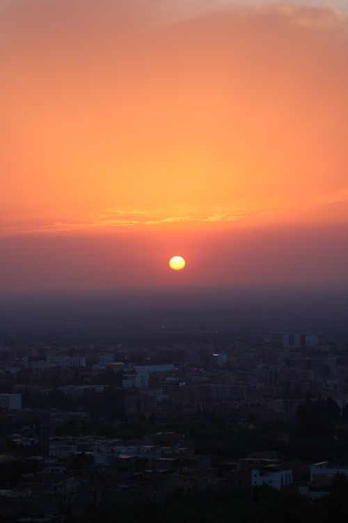 Free A breathtaking sunset over Béni Mellal, Morocco, casting vibrant colors across the cityscape. Stock Photo