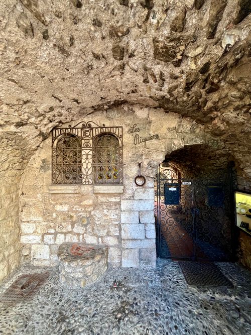 Free Stone archway in Èze with decorative ironwork, showcasing medieval charm. Stock Photo