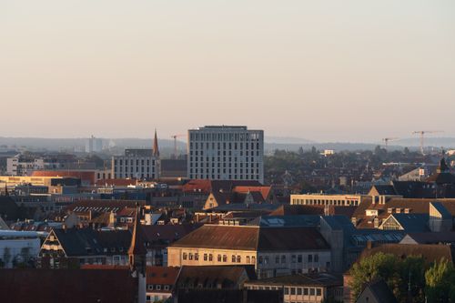 Free A vibrant city skyline showcasing modern and historical architecture at sunrise. Stock Photo