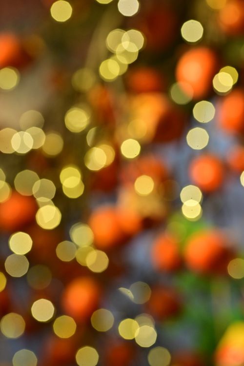 Free A colorful bokeh effect with festive lights creating a warm, dreamy atmosphere. Stock Photo