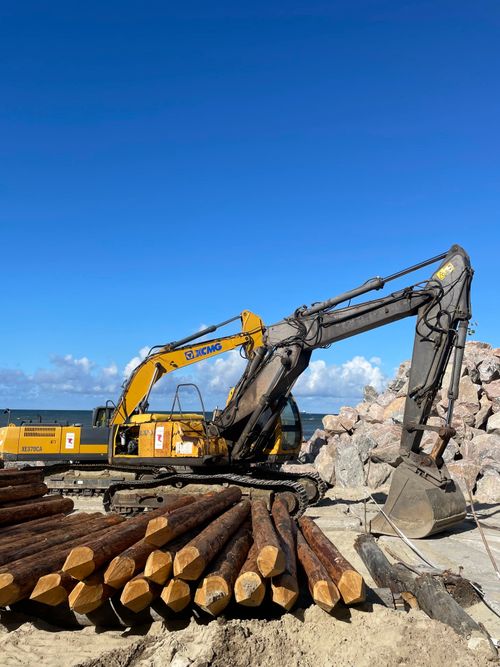 Free Excavator working on beachfront construction site in Svetlogorsk, Russia. Stock Photo