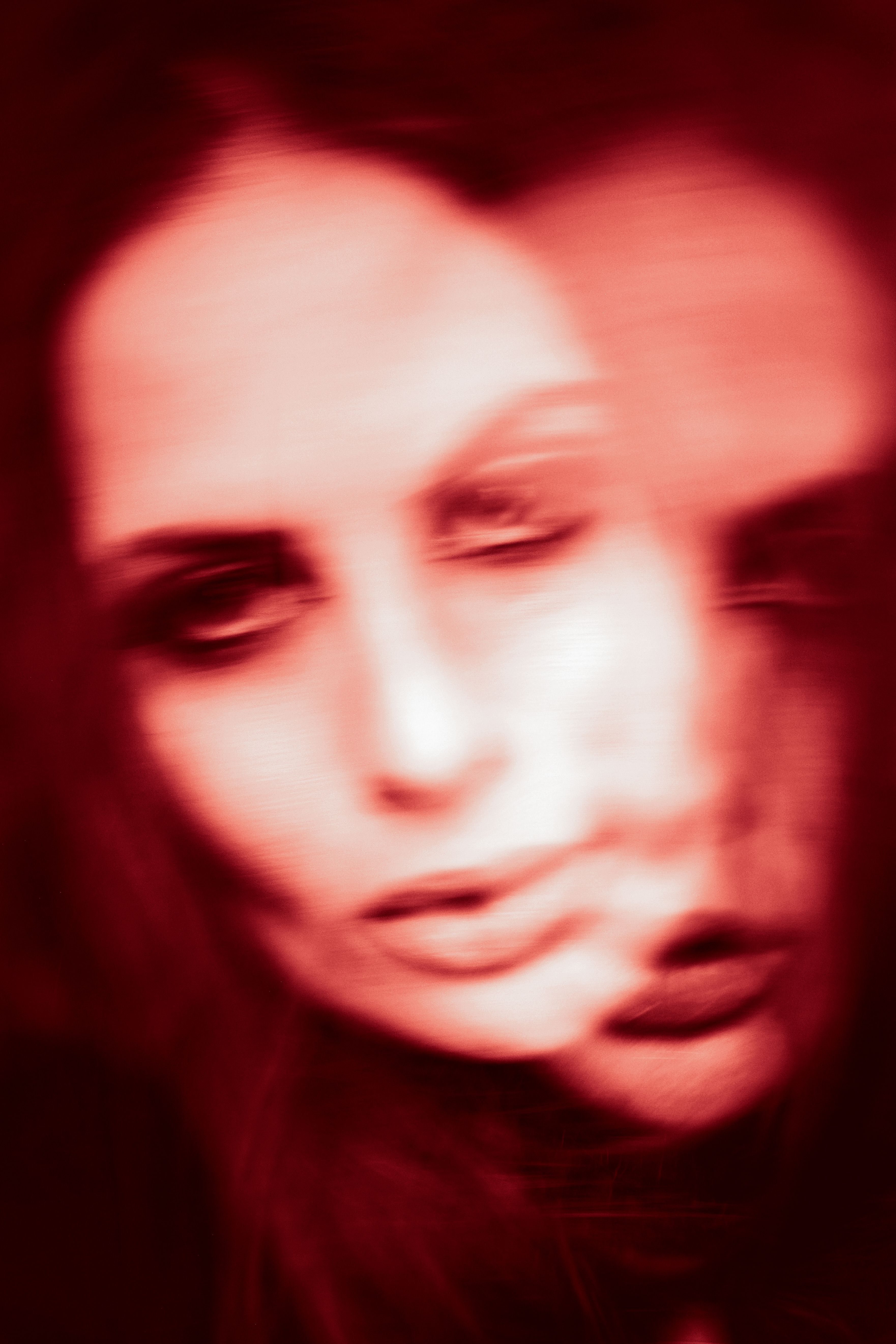 A creative blurred double exposure photo of a woman, conveying surreal and dreamlike emotions.