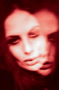 A creative blurred double exposure photo of a woman, conveying surreal and dreamlike emotions.