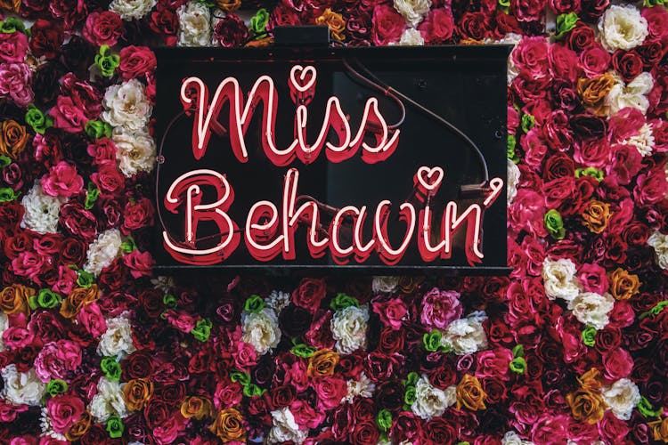 Miss Behavin' Sign On Flowers