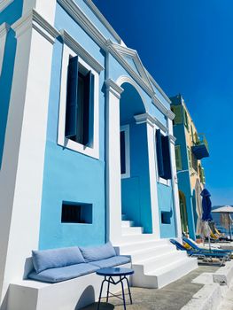 A vibrant blue Mediterranean building with classic architecture, perfect for travel inspiration.