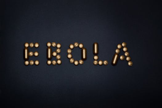 Medicinal pills arranged to spell 'EBOLA', symbolizing treatment and healthcare theme.