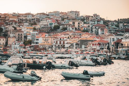 Free Explore picturesque Parga, Greece, with its colorful hillside houses and vibrant harbor filled with boats. Stock Photo