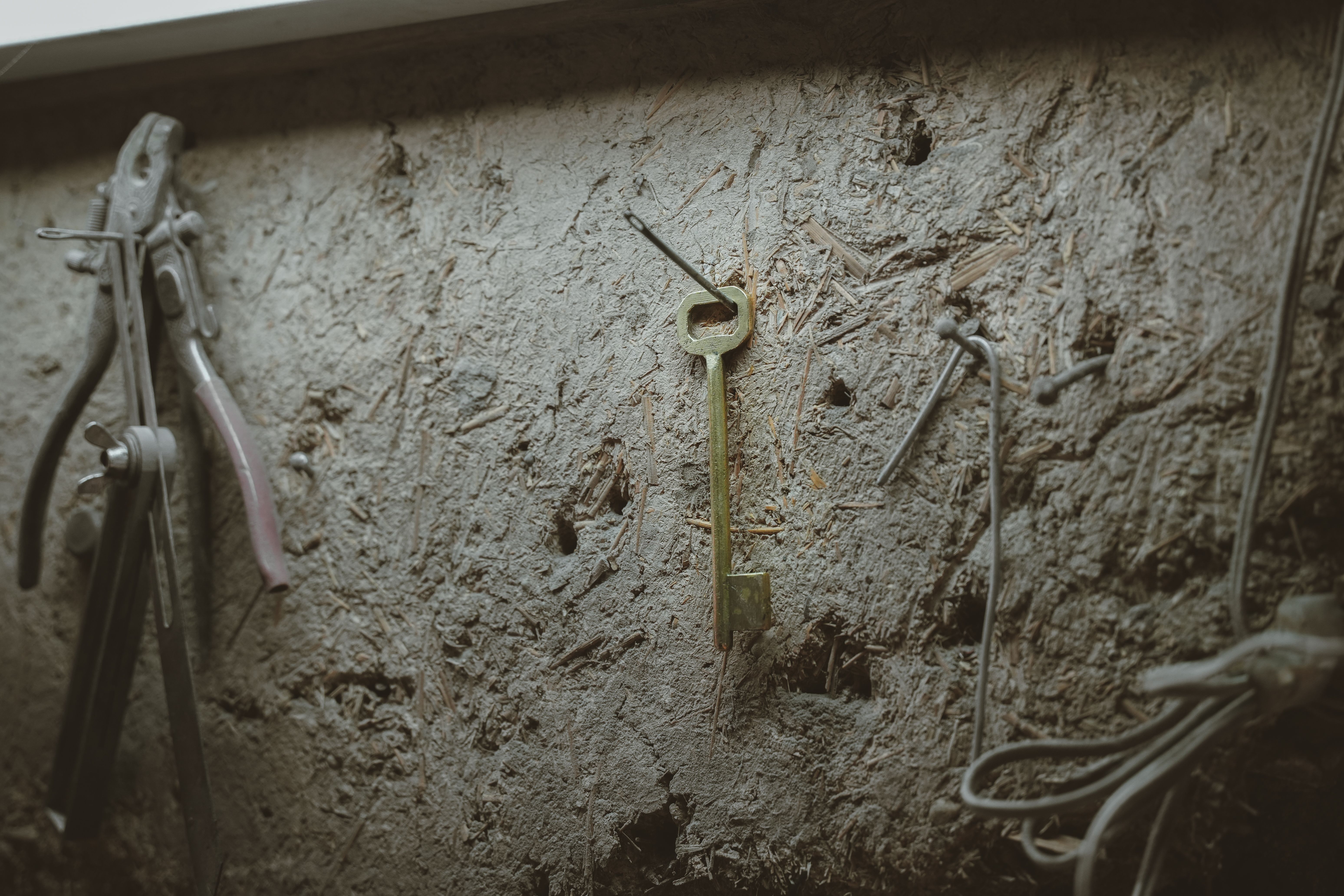 A key hanging on a nail on a workshop wall - The Apprentice Paper