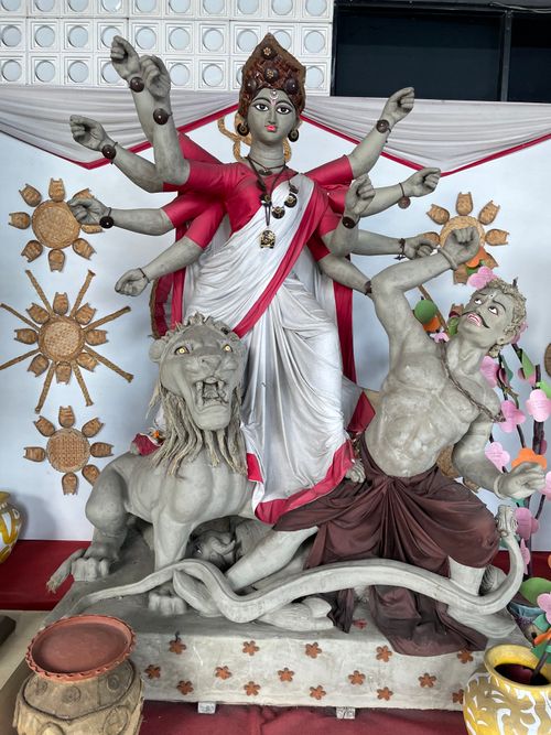Free A vibrant Durga idol with multiple arms, lion, and demon for a festive ceremony. Stock Photo