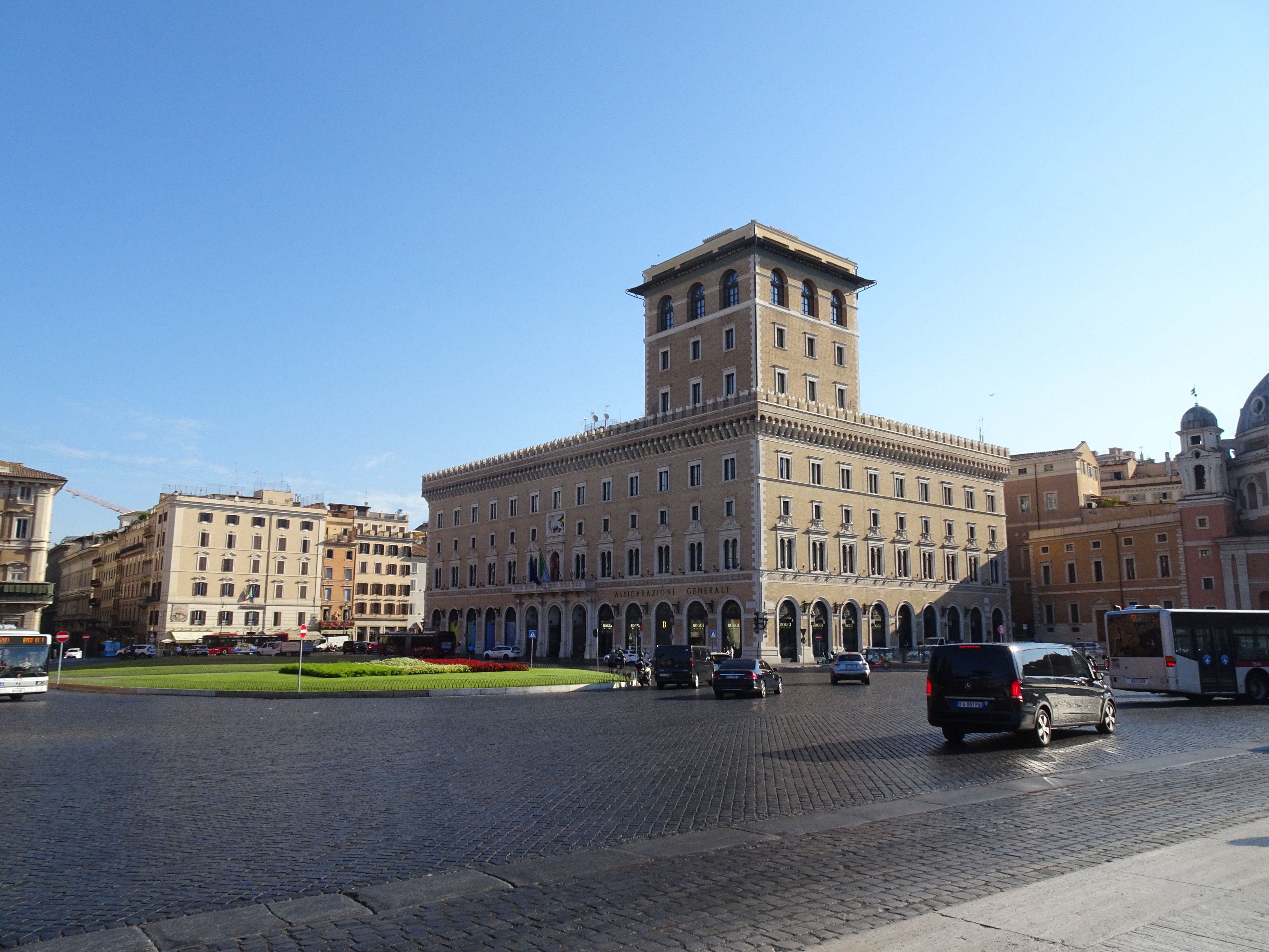 Classic Roman architecture with a bustling street scene in central Rome, Italy.