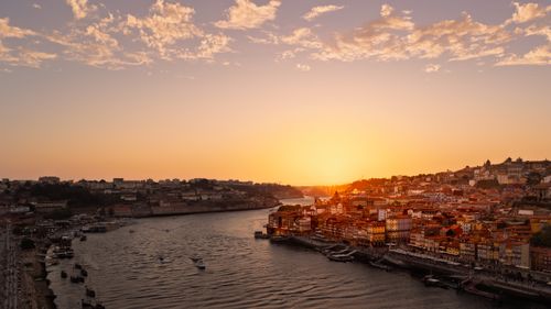 Free Stunning sunset over Porto, Portugal with a view of the Douro River and historic buildings. Stock Photo