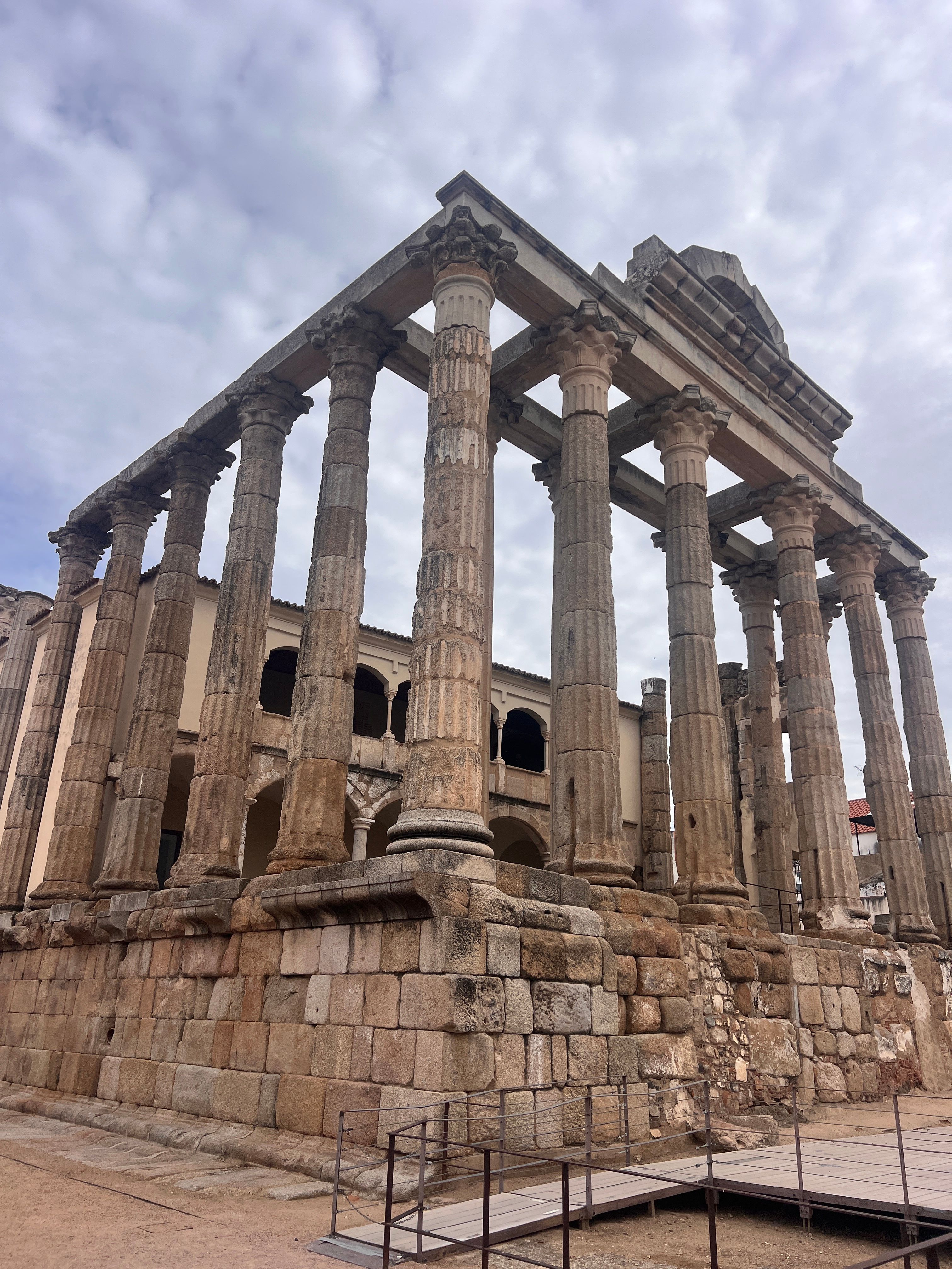 The majestic Roman temple of Mérida showcases its historical elegance under an overcast sky.