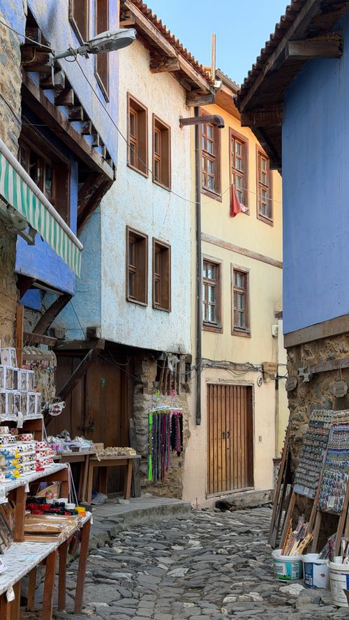 Free Colorful traditional architecture on a cobblestone street in Bursa, Türkiye's historic center. Stock Photo