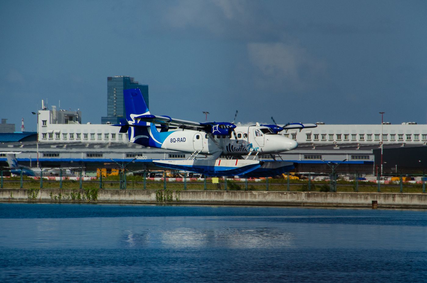 A seaplane parked at the water's edge at Malé airport in the Maldives